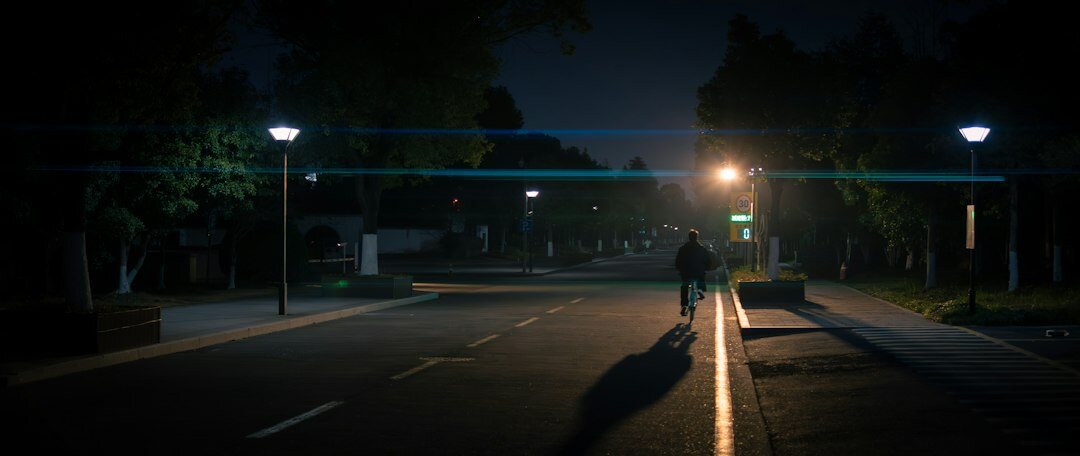 person walking alone on dark street